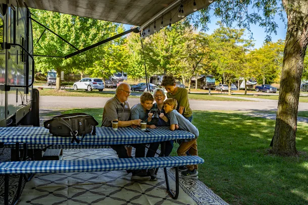 Children with Grandparents looking at camera at Sauder Village Campground