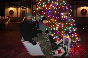 A family at the Merry and Bright holiday event