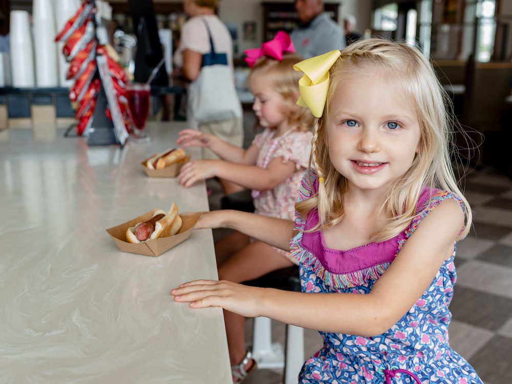Children enjoying hot dogs at Sauder Village